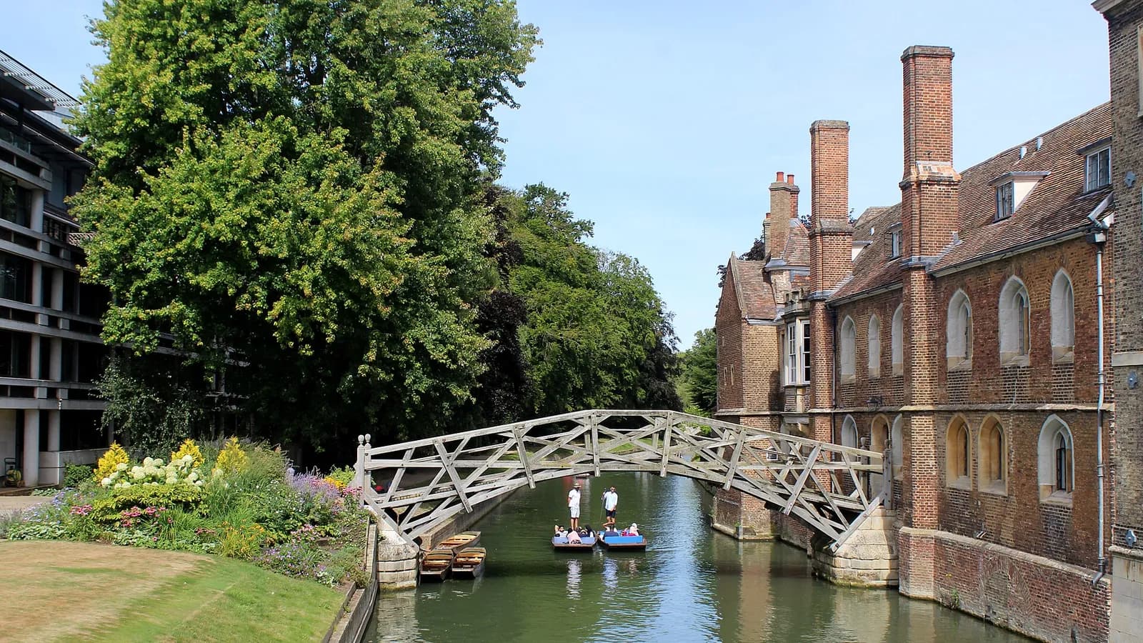 A punt passing under the wooden Mathematical Bridge at Queens’ College on the River Cam, Cambridge